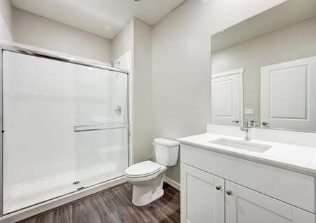 The Crystal floor plan secondary bathroom with a walk-in shower, a sink, cultured marble countertops and white cabinets.