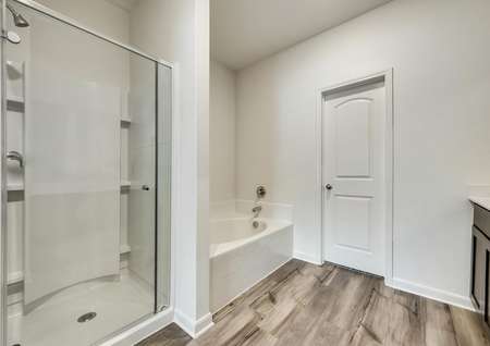 The master bath has a glass enclosed shower and large soaker tub.