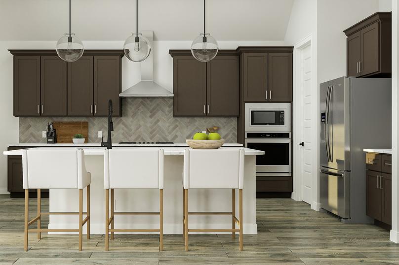 Rendering of the spacious kitchen
  featuring grey cabinetry, stainless-steel appliances, wood-look flooring and
  herringbone backsplash. A view of the dining room is to the left.