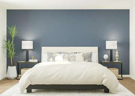 Rendering of owners bedroom with large
  bed, blue accent wall and dual side tables, adjacent to bathroom.