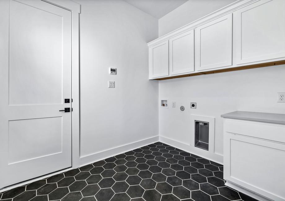 The mud room offers additional storage space and the perfect setup for laundry.