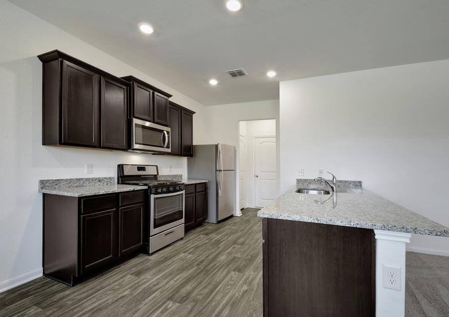 Chef-ready kitchen with stainless steel appliances, granite countertops, and wood-style flooring.