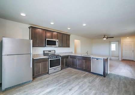 Kitchen with stainless steel appliances, wood-like flooring, granite countertops