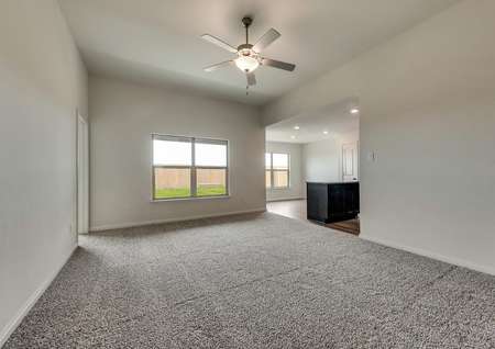 The family room has great natural light and a ceiling fan.