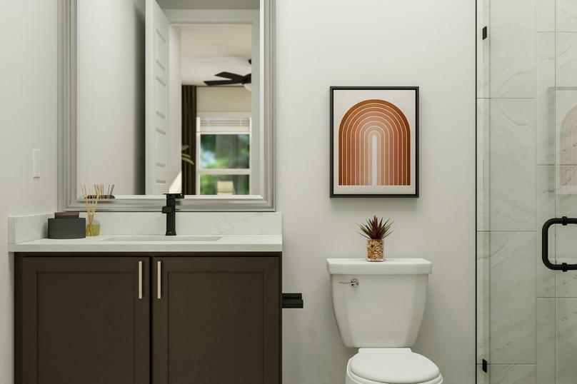 Rendering of the secondary bathroom  showcasing a modern vanity, toilet, and glass framed shower.