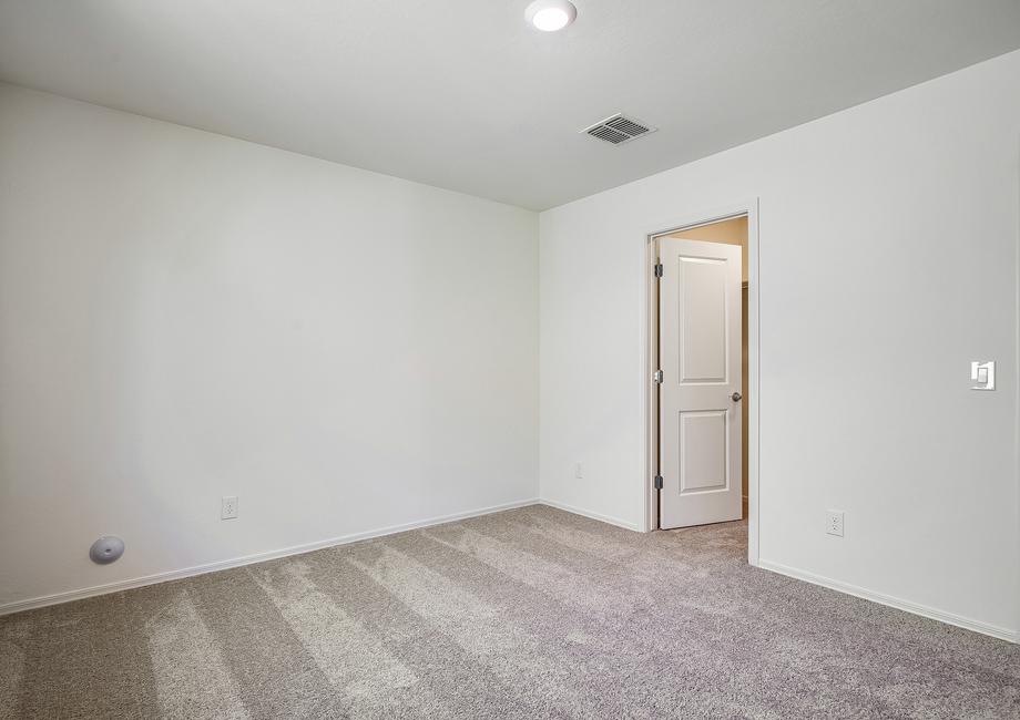 The master bedroom is the perfect retreat after a long day, with an attached master bathroom.