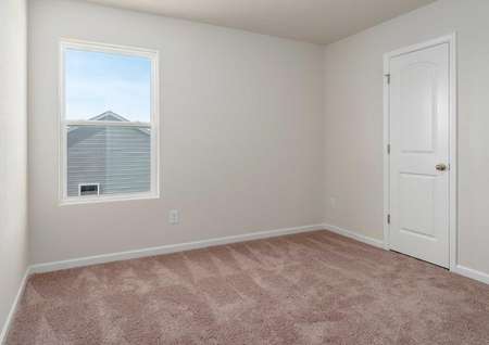 Avery plan room with bay window, brown carpeted flooring, and walk-in closet