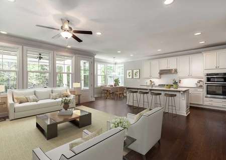 Living room and kitchen with wood floors and stainless steel appliances.