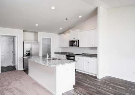 Chef-ready kitchen with oversized island, granite countertops and stainless steel appliances. 