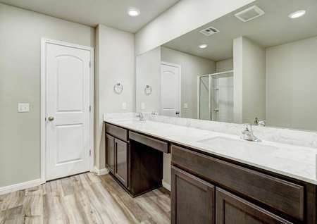 The master retreat features its own full bathroom with a double-sink vanity, a step-in shower and a garden tub.