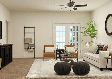Rendering the spacious Maple living room with doors leading to the back yard, carpeted flooring and tan walls. Decorated with a couch, two armchairs, coffee table and entertainment center.