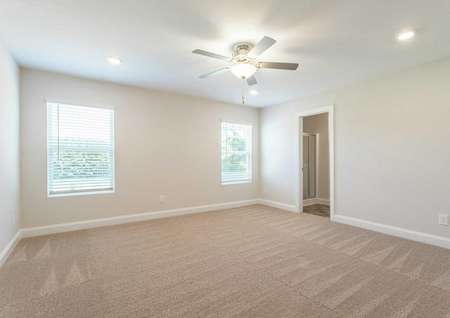 Craven master bedroom with recessed lights, ceiling fan, and carpet floors