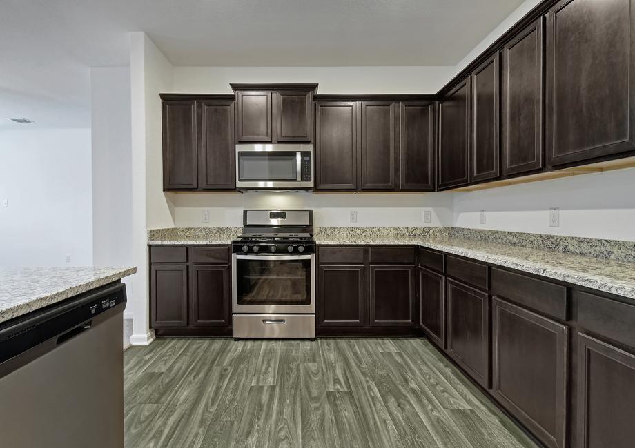 Whether you love cooking or not (yet), you will appreciate the stunning cabinetry with crown molding, wood-style flooring, and abundant outlets.