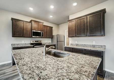 Feast your eyes on the sprawling granite countertops found in the home's kitchen.