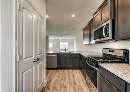 The kitchen comes with a full suite of stainless steel appliances and light granite countertops.