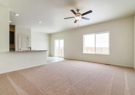 Spacious living room with ceiling fan and sliding doors to the back patio.