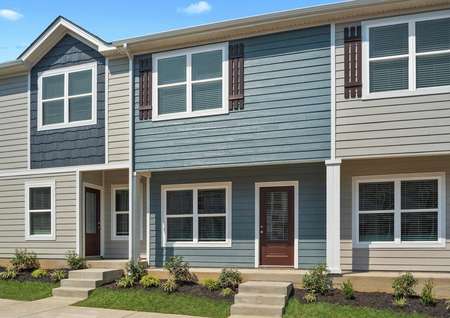 This townhome has a charming blue exterior with the added detail of window shutters.