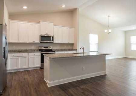 Burton kitchen with granite island, stainless steel appliances, and wood flooring