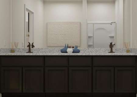 Rendering of the master bath in the Anna,
  which has a dark brown vanity with two sinks and granite countertops. A linen
  closet is visible on the right.