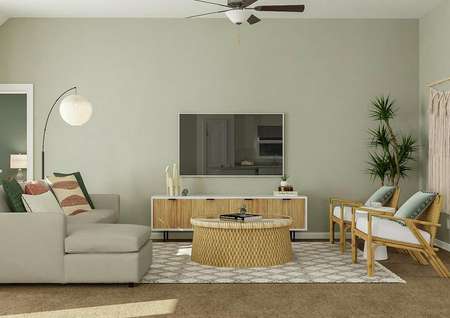 Rendering of living room with round
  coffee table, large storage space, and tv above storage.