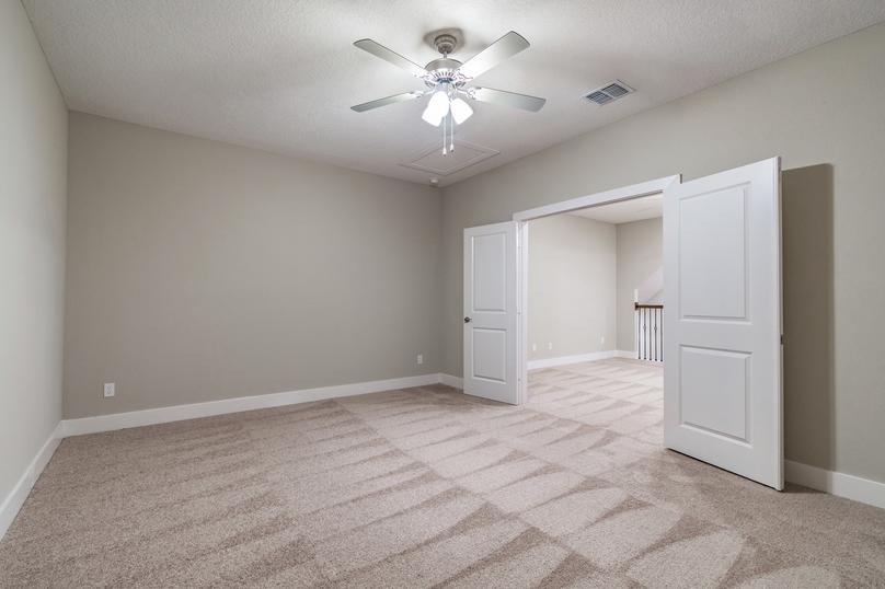 Media room located off of the game room with carpet and a fan.