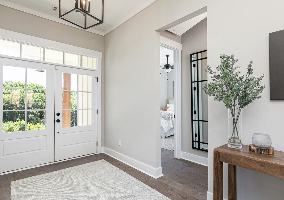 Entryway with white door and iron light fixture.