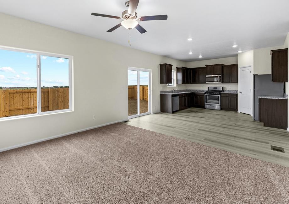 Open-concept layout with a spacious family room, dining area, and upgraded kitchen. 