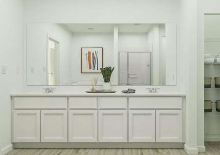 Rendering of the spacious master bath in
  the Anna floor plan, which has a large double-sink vanity with white
  cabinetry, a linen closet and wood-style flooring.