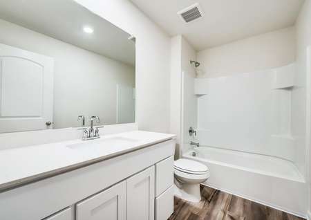 A full bathroom with large countertop space.