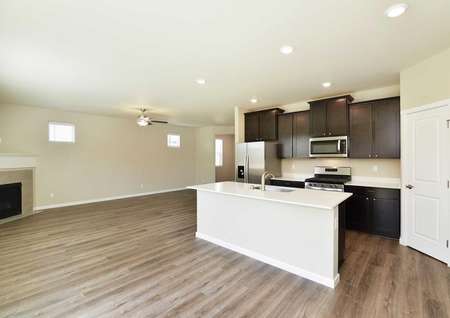 Larch dining area and kitchen with wood floors, recessed lights, and plenty of counter space