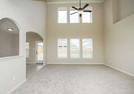 Carpeted living room with ceiling fan and light in the Redwood floor plan